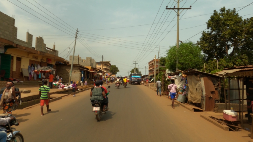 FREETOWN, SIERRA LEONE - 14 FEB 2021: Freetown Sierra Leone busy city street POV part 1. Coast of west Africa is a nation that suffers with extreme poverty and hunger. Congested crowded roads. Royalty-Free Stock Footage #1069860424