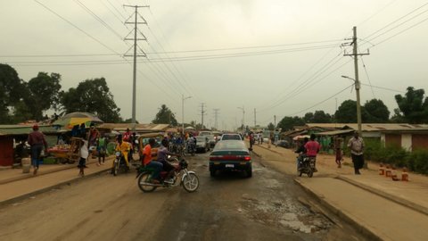 MONROVIA, LIBERIA - 15 FEB 2021: Monrovia Liberia urban crowded street drive POV. West Africa is historical country beautiful beaches, history Civil wars, Ebola, COVID, economic failures.