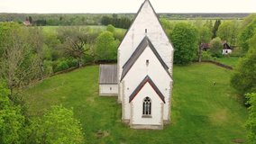 Muhu Island in the Baltic sea, Saare County, Estonia. Beautiful 4K panoramic aerial video from flying drone to Muhu St. Catherine's Church, (Muhu Katariina kirik) on a sunny summer day. (Series)

