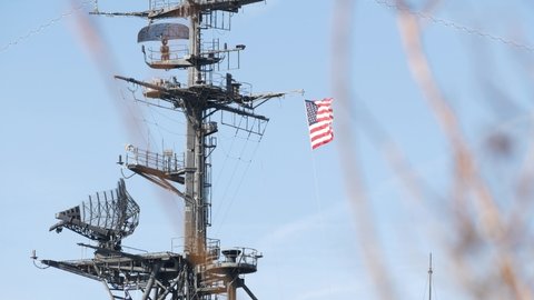 SAN DIEGO, CALIFORNIA USA - 4 JAN 2020: Radar of USS Midway military aircraft carrier, historic war ship. Naval army battleship with American flag. Maritime steel warship in port, navy fleet symbol.