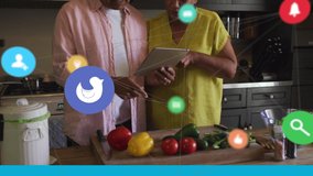 Network of digital icons against senior couple using digital tablet in the kitchen at home. global networking and technology concept - Powered by Shutterstock - Get 15% off with code: PIKWIZARD15