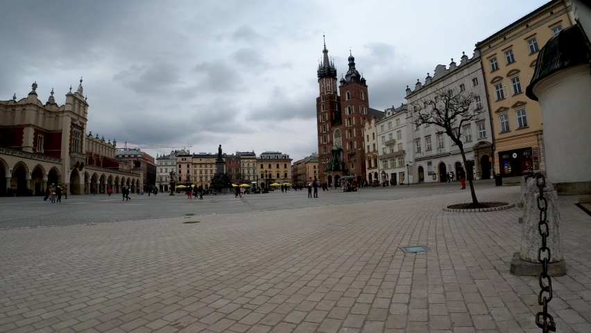 Krakow, Poland - March 27, 2020: Time lapse of Saint Mary's Church at Main market square in the old town center of Cracow city against dramatic stormy black overcast clouds, Europe | Shutterstock HD Video #1069871164