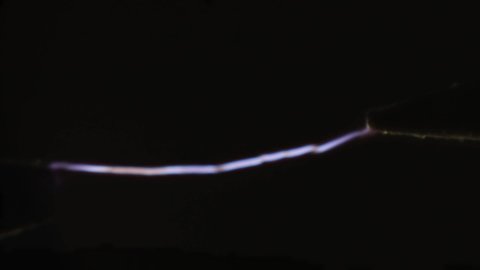 Realistic glowing electricity lightning between two electrodes. Industrial electricity concept. Macro shot. Selective focus