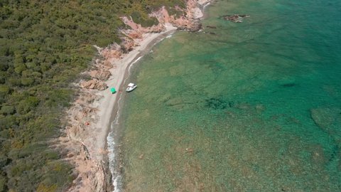 Mediterranean Coast With Beach And Crystal Clear Blue Sea Waves During Summer In Sardinia, Italy - aerial drone shot