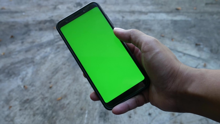 Point of View of Man Using Phone With Green Mock-up Screen Chroma Key watching content shifting Screen to the left side. Royalty-Free Stock Footage #1069880353
