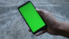 Point of View of Man Using Phone With Green Mock-up Screen Chroma Key watching content shifting Screen to the left side. - Powered by Shutterstock - Get 15% off with code: PIKWIZARD15