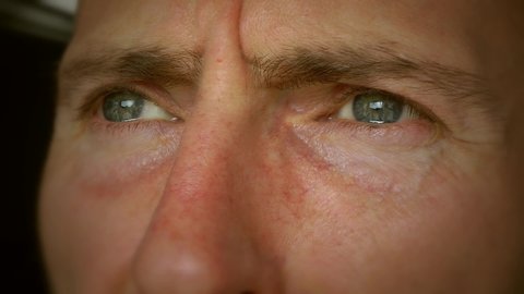 A close up of a mans eyes. Sad, crying and in despair. Men's mental health awareness. Middle-aged men midlife crisis. Male depression, male suicide and anxiety. Filmed 50fps.  