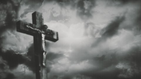 Jesus Christ crucified at Golgotha hill outside ancient Jerusalem. The Crucifixion of Christ with stormy clouds time lapse. Vintage film look