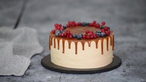 Delicious caramel cake with frozen summer berries.