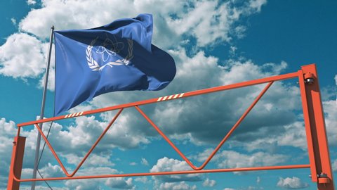 Manual swing arm road barrier and flag of the IAEA. Editorial restrictions related 3d animation