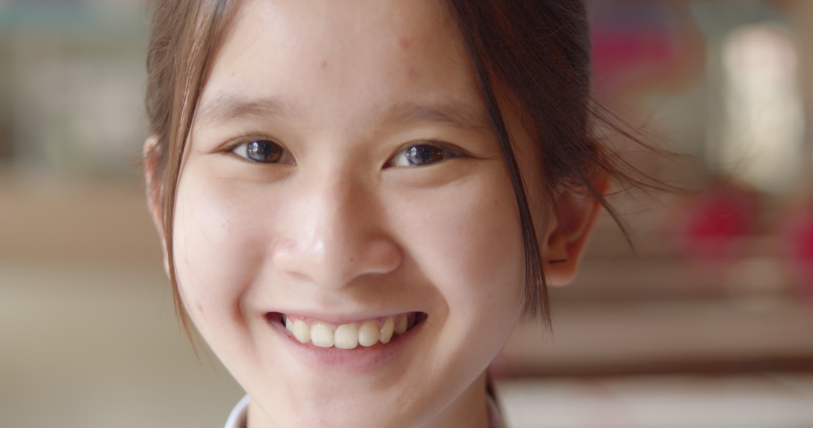 A young Asian teenage high school student girl is smiling happily. | Shutterstock HD Video #1069905205