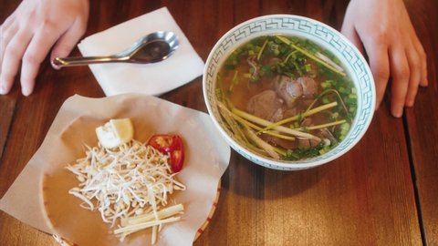 Pho Vietnamese Soup, Asian street cafe. Vietnamese noodle soup, pho soup. Tourist enjoy street food.