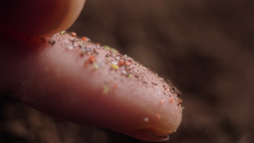 pieces of microplastic on the finger. primary and secondary microplastics. small plastic pellets in human hands. soil contamination, marine plastic pollution, environment, ecology, earth Royalty-Free Stock Footage #1069922182