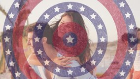 Animation of american flag circles spinning over laughing man carrying woman piggyback on beach. usa patriotism, celebration and democracy concept digitally generated video.