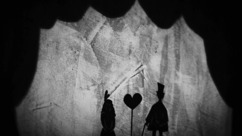 Old folk story about man and woman in love. Romance, gentleman and woman and a heart symbol cartoon. Animation, shadow theatre, puppets of a gentleman and a lady projected on a wall.
