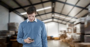 Animation of man talking on smartphone with stacks of boxes in warehouse. global shipping and technology concept digitally generated video.