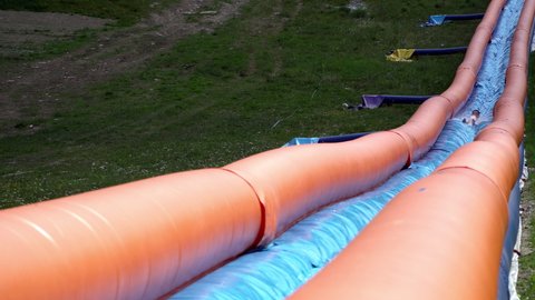 Water slide tubing on inflatable waterslide. Enjoying long inflatable, water slide