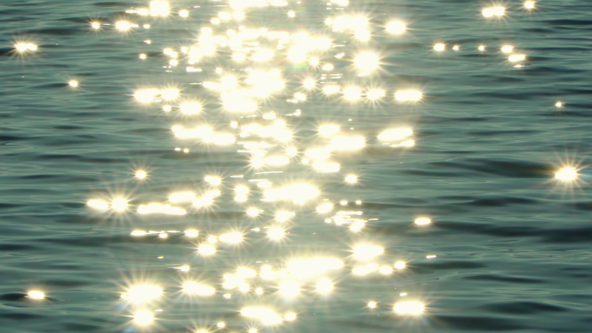 Sun reflecting on sparkling blue sea, ocean at sunset, sunrise Royalty-Free Stock Footage #1069931506