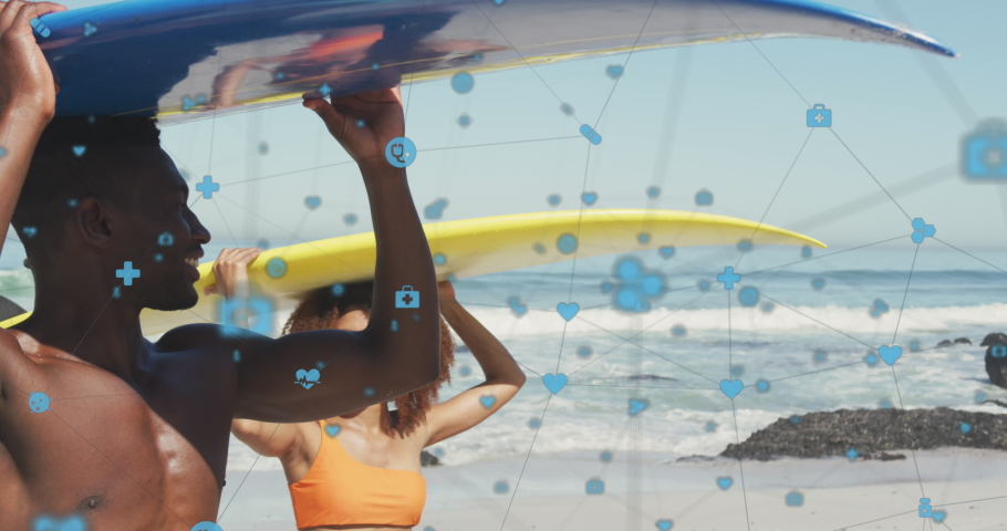 Animation of network of connections with icons over couple carrying surfboards on beach. digital interface, social media and global technology concept digitally generated video.