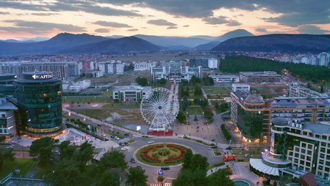 Sunset sky over sustainable eco city planned with green urbanism in mind. Aerial view of buildings, streets and parks in commercial and residential district of Podgorica Montenegro, Europe Mar 30.2021