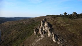 Panorama of rocky hills and winding river on sunny weather.