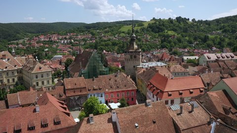 Sighisoara, Romania, July 28, 2019. Aerial of Romania sightseeing Clock Tower, tourists exploring the castle. The biggest clock tower in Eastern Europe in medieval style
