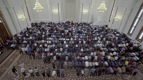 Baku, Azerbaijan -2017: Men attend Friday prayers at a mosque during Ramadan. Muslim pilgrims and worshipers. Muslims pray at the largest mosque in Baku