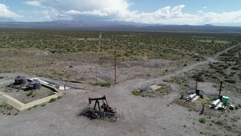 Mendoza, Argentina, March 13, 2021: aerial view Oil Battery Gathering  Distribution System. Gas oil distribution station with cisterns on a yellow field with pumps pumping oil