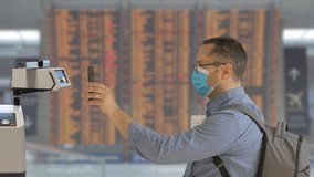 Man scanning digital health passport on phone in airport, free tourism travel mobility during COVID - Powered by Shutterstock - Get 15% off with code: PIKWIZARD15