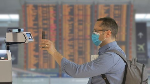 Man scanning digital health passport on phone in airport, free tourism travel mobility during COVID