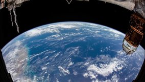 Beautiful 4K time lapse of Earth seen from space through a fish eye lens. Shot during sunrise with lens flare from the Sun. Image courtesy of NASA.