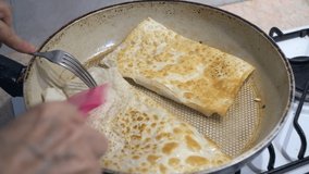 Frying gozleme in pan at home. Gozleme is a traditional Turkish food.
