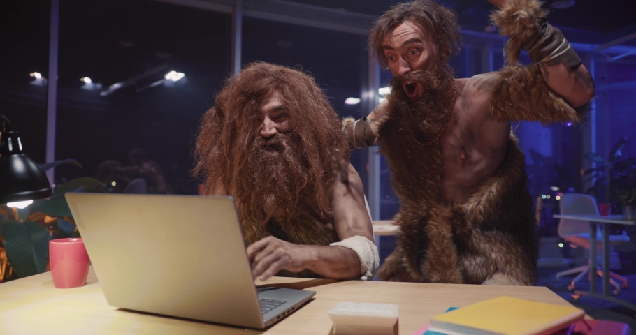 Couple of funny neanderthdal prehistoric humans collecting money working in corporate office winning lottery successful business celebrating together. Homo sapiens. Royalty-Free Stock Footage #1069970473