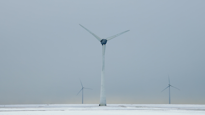 Wind turbines in snow covered field