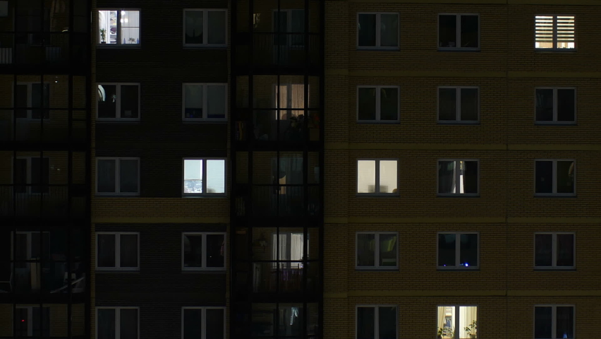 blinking windows of the building at night zoom out, time lapse Royalty-Free Stock Footage #1069979044