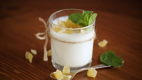 Sweet homemade yogurt with candied fruits in a glass