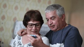 Happy older couple reacting to good news on cellphone. Senior husband sharing smartphone screen with wife. - Powered by Shutterstock - Get 15% off with code: PIKWIZARD15