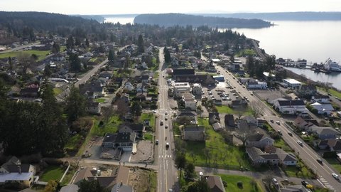 Cinematic drone aerial orbiting footage of Steilacoom, Pioneer Orchard Park, Sunnyside Beach Park, Anderson Island ferry terminal by Puget Sound, near Lakewood, Tacoma in Pierce County Washington
