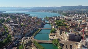 Stunning aerial footage of Zurich old town and downtown along the Limmat river and lake Zurich in Switzerland largest city