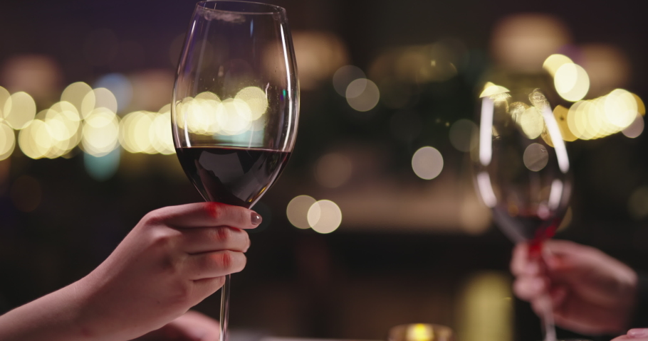Joyful couple having a romantic dinner at a fancy restaurant. People enjoying their date, drinking wine, eating and chatting 4k footage | Shutterstock HD Video #1069994935