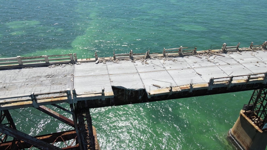 Old Seven Mile bridge in the Florida Keys south of Marathon. Beautiful green Gulf of Mexico waters below. Concrete and iron cannot resist the salty environment and hurricane pressures. Royalty-Free Stock Footage #1070007604
