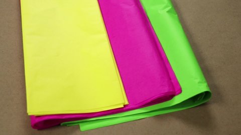 Tissue paper in bright colors: yellow, pink and green. Paper for crafts, piñatas and decorations.