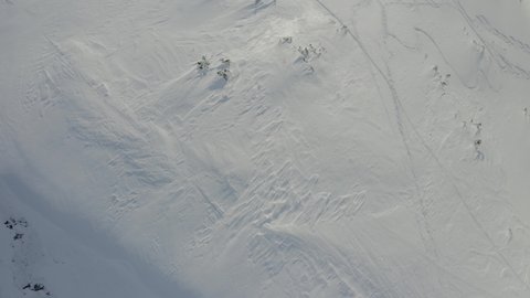 Birds eye over snowy Austrian mountain covered in glistening white powder