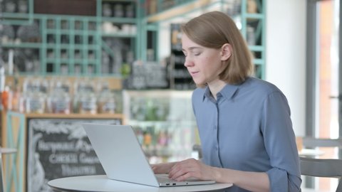 Woman having Back Pain while using Laptop