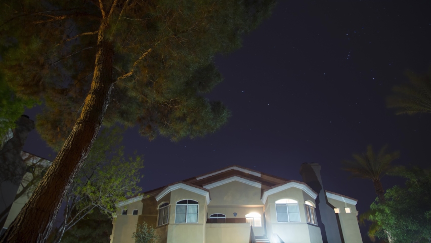 Star trails time lapse, over the building. Low angle. 