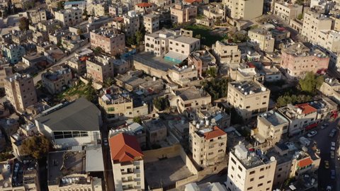 Drone video of a city with Arabic old architecture. Central part with historic houses and their roofs on the streets in the cityscape. Aerial view Amman Jordan.
