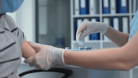 pandemic, close up hands of medical nurse in safety gloves is making a vaccine injection to little boy patient in a health clinic - Powered by Shutterstock - Get 15% off with code: PIKWIZARD15