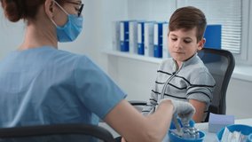 children health, woman doctor in a mask and glasses gives an injection to boy patient in a hospital - Powered by Shutterstock - Get 15% off with code: PIKWIZARD15