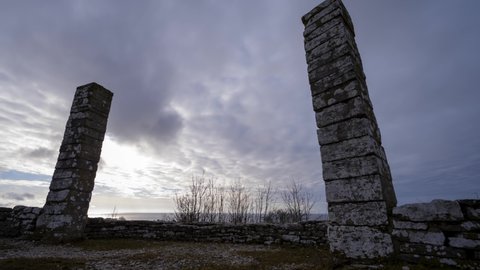 Clouds passing over medieval stone gallows in time lapse