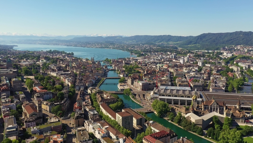 Stunning aerial footage of Zurich old town and downtown along the Limmat river and lake Zurich in Switzerland largest city